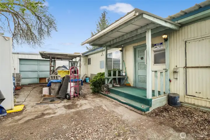 Go in through the back door where you'll walk through the utility room to come into the house.