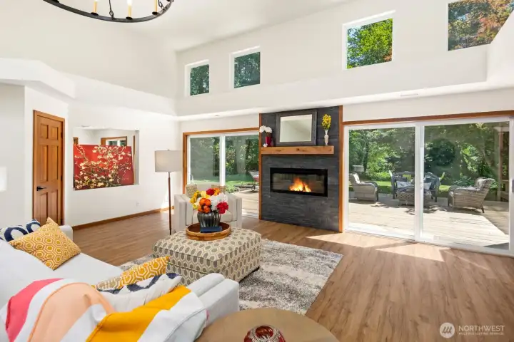 A beautiful stone fireplace sets the stage in the living room and large sliders open to the gorgeous back deck.
