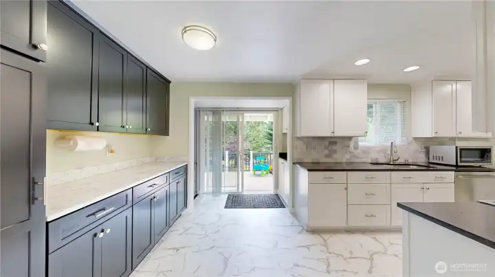 Large, sunlit kitchen with a dedicated eating space, ample cabinetry, and seamless flow into the living areas.