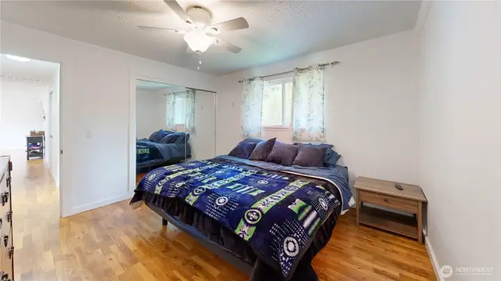 Primary suite with vaulted ceilings, large closet space, and warm natural lighting.