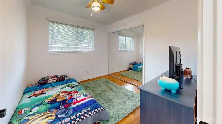 Second bedroom with large windows and updated flooring—ideal for guests, a nursery, or a home office.