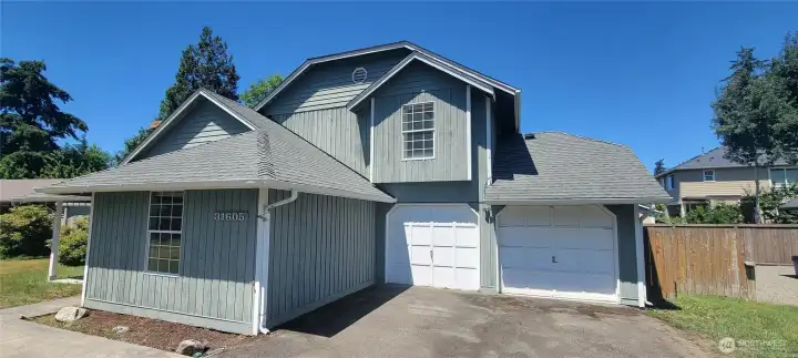 Garage and side gate to the fenced backyard.