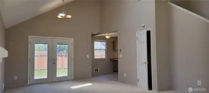 Dining room with french doors leading into the fully fenced back yard patio.