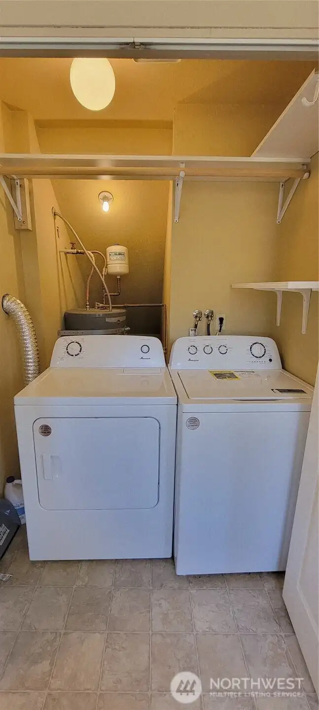 Utility closet behind double doors in the kitchen with the washer and dryer.
