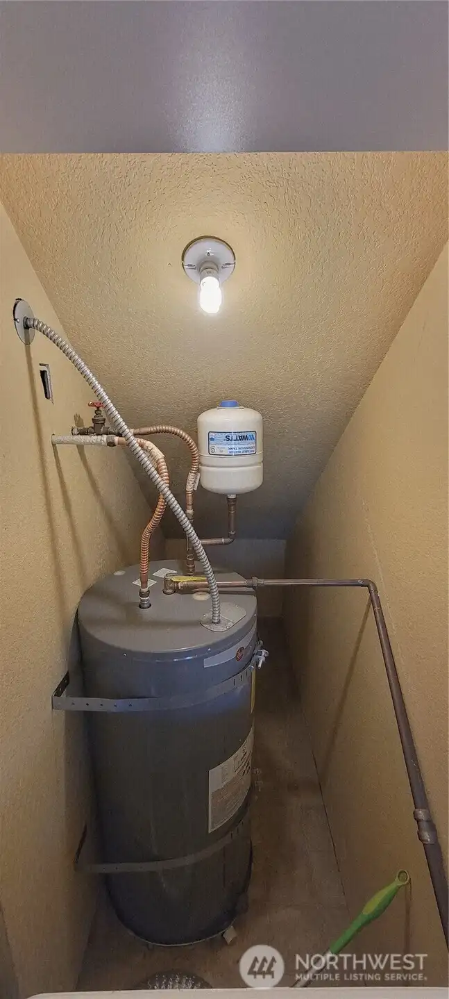 Water heater behind the washer and dryer.
