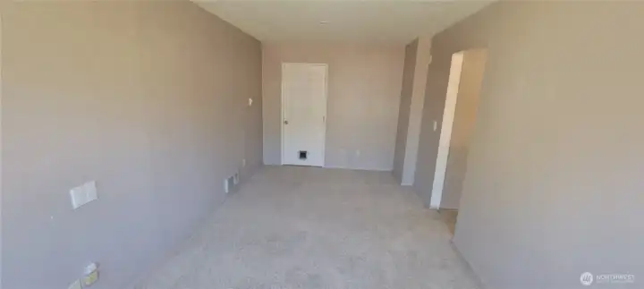 View from the opposite side of the bonus room.room. Door leads into the garage.
