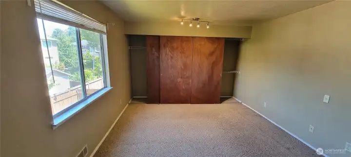 Master with huge closet with solid wood double doors and built in shelving.