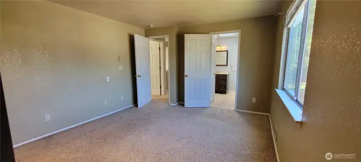 Master taken from the closet side looking into the attached full bath and entry door.