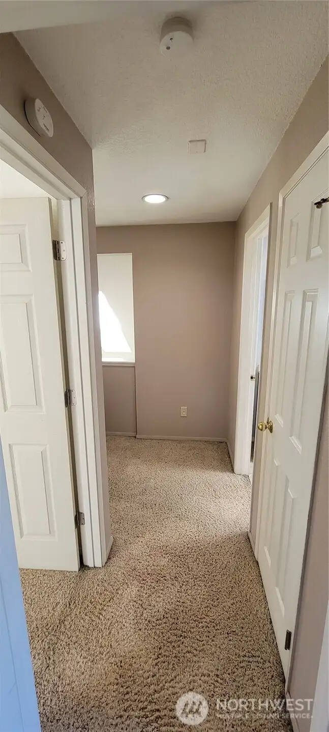 Looking down the hallway from the master.  The other bedroom is on the left and a linen closet and full bath on the right.