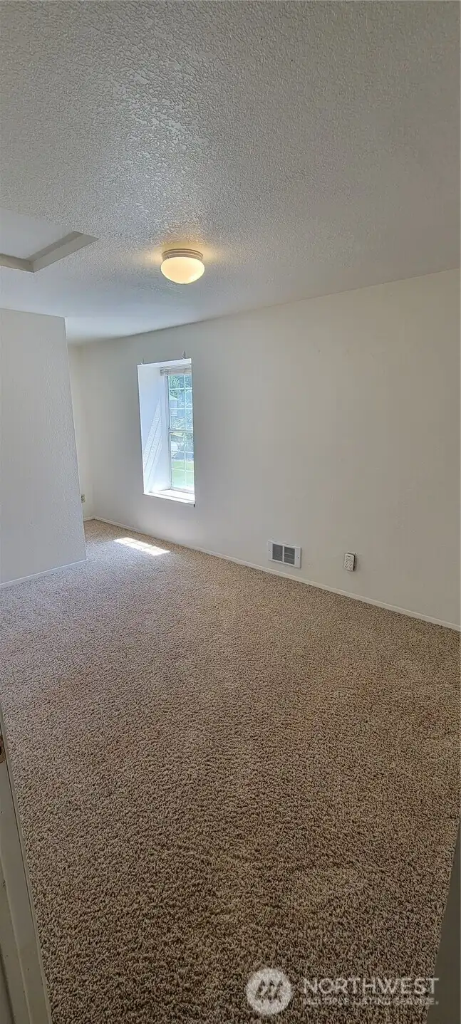 Second upstairs bedroom with window seat looking out over the front yard.