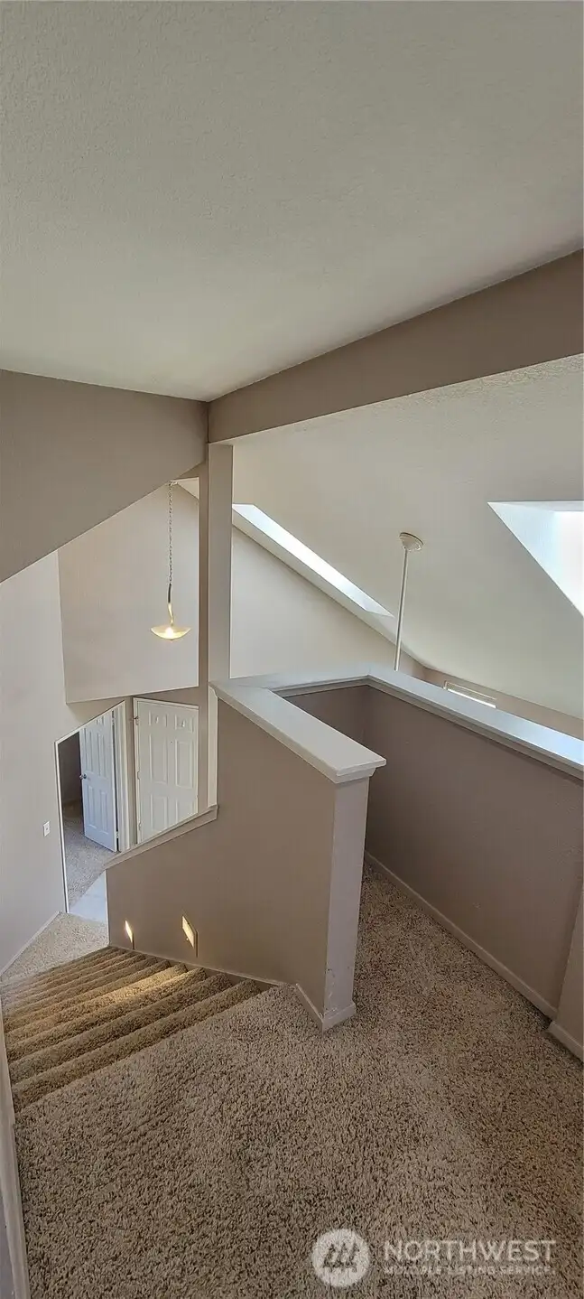 Heading back downstairs, notice the light coming in from the skylights.