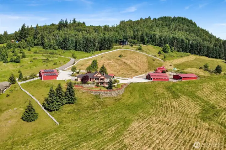 Fenced 30-acres with a custom home, shop, barns, and outbuildings.
