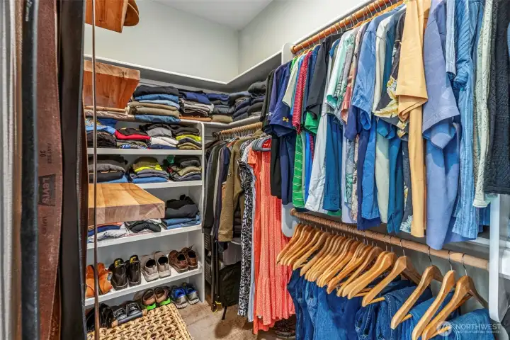 Walk in closet in primary bedroom.