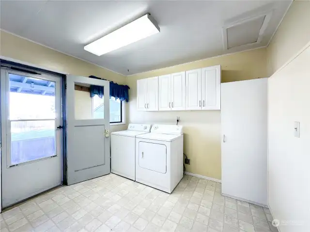 Huge laundry/mud room with backyard access