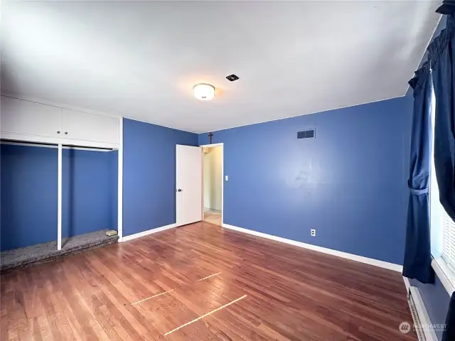 Guest bedroom 1 of 2 with exposed hardwoods