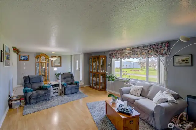 Large well lit living room looking towards the main entry
