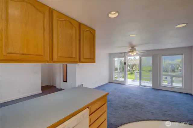 Apartment living, kitchen and dining area. The sliding door takes you to the rear deck and fully fenced, landscaped back yard.