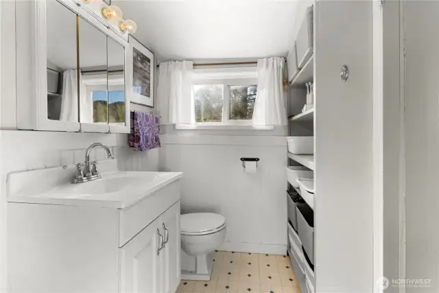 Bathroom has tub with shower.