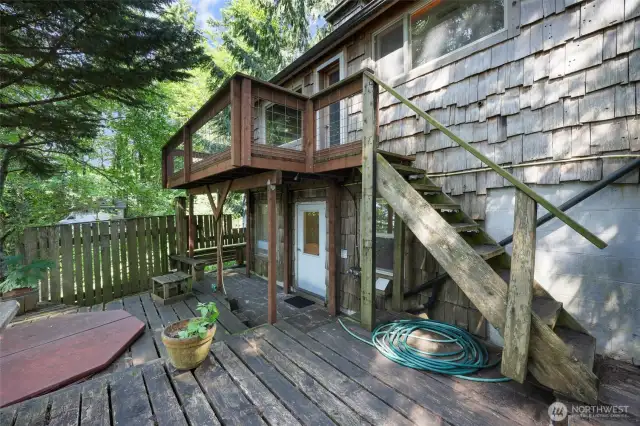 Hot tub among the trees with views of the water.