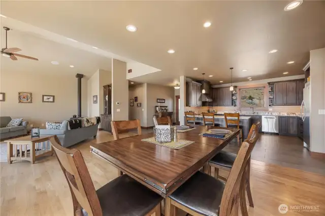 Hardwood floors lead into the kitchen spaces.