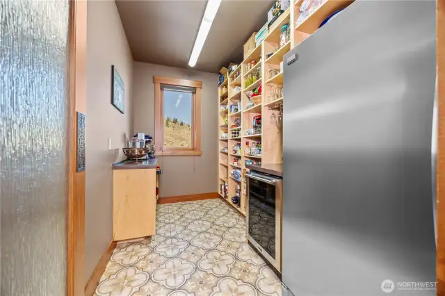 Walk in pantry with additional fridge and wine cooler.