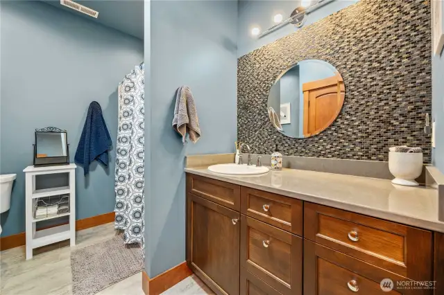 Main bathroom with a two sink vanity and walk-in shower.