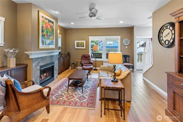 Living room with fireplace, custom millwork and hickory hardwood floor.