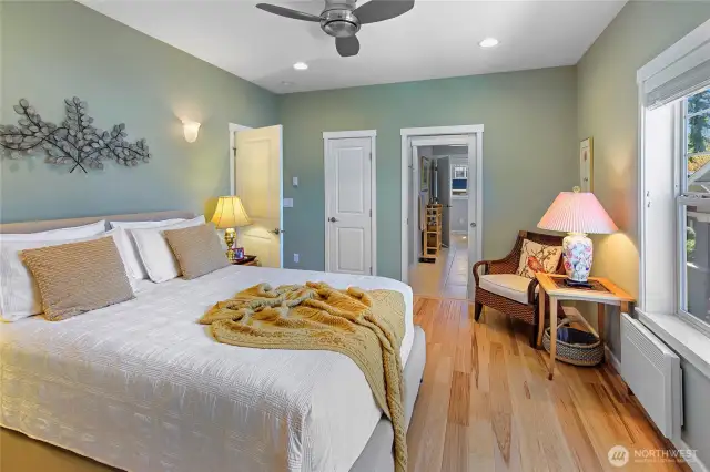 Primary bedroom with smaller closet at left and entry to bath at right.