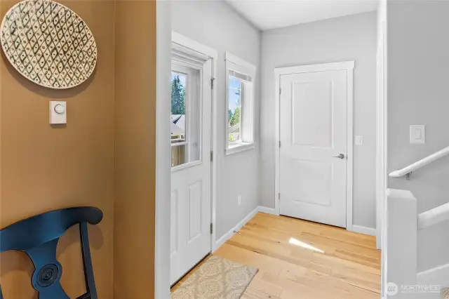 Vestibule at front porch and stair to upper level with guest coat closet.