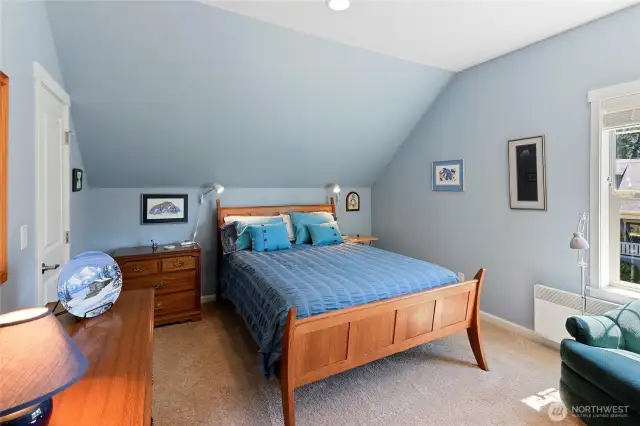 Full guest bedroom with closet at south end of upper level.