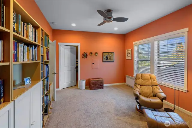 Guest bedroom with large walk-in closet/storage. Bookcases will remain with the home.