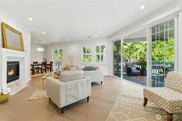 Living room flows into dining area- windows offer custom plantation shutters, upscale shades and sliding glass doors to invite the outside in!