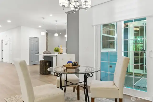 Kitchen nook just off kitchen with access to back covered porch. This view provides you to see the walk in pantry off the kitchen!
