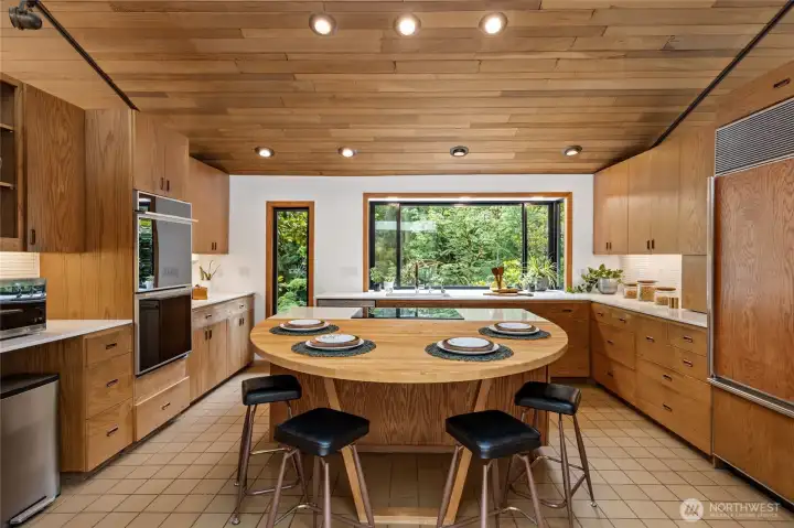 Chefs will delight in the incredible kitchen, outfitted with an induction cooktop, new quartz counters, double ovens, refinished original cabinetry, and tons of storage.