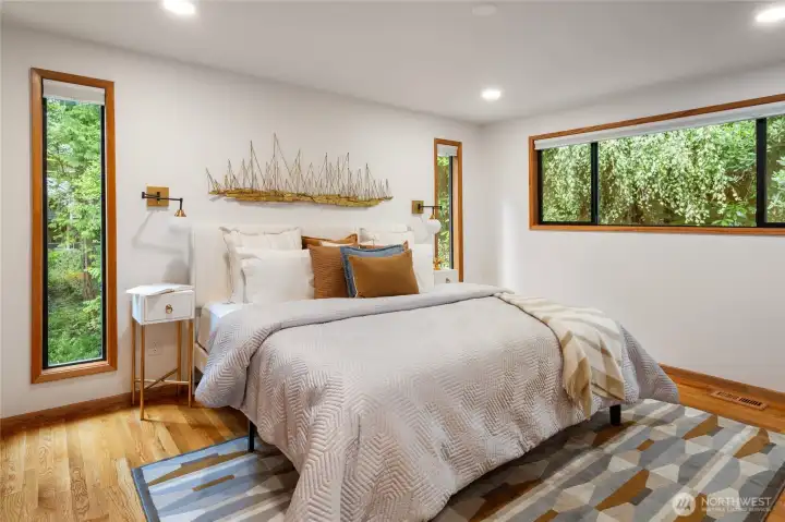 The spacious primary suite is on the main floor, includes dual closets, and has plenty of room for a king-sized bed.