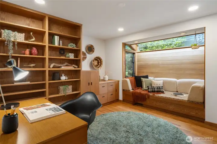 This second bedroom would make the coziest home office! Complete with built-in shelving, a Murphy bed, and an awesome bench seat/daybed by the window.