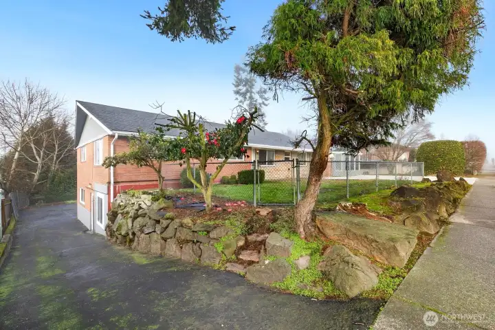 Driveway along South side of property leads to lower level unit.