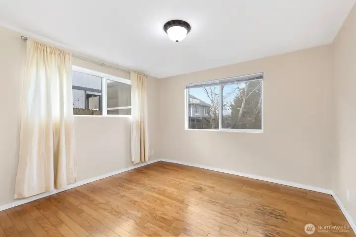 Inviting lower unit bedroom #2 with bright, airy windows.