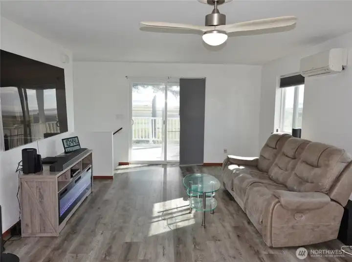 Living Room with ceiliing fan and a slider glass door to the Large Covered Deck.