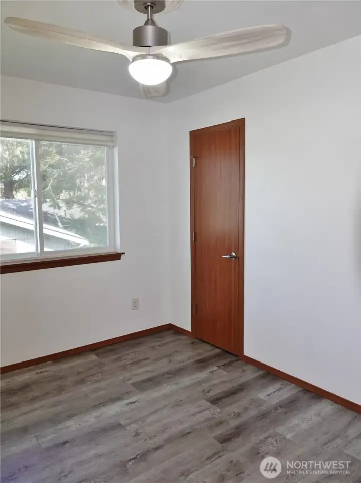 Bedroom #2 with ceiling fan and a small walk-in closet.