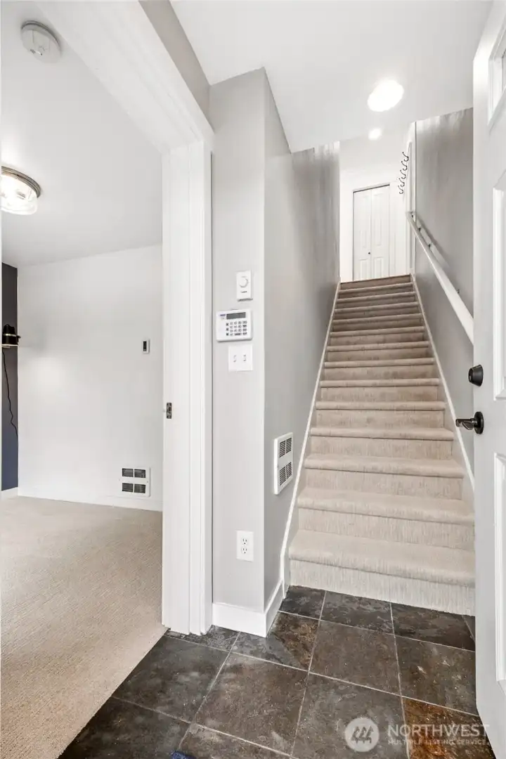 Entryway with adjacent den/office/flex room. The garage is accessible through this room as well.