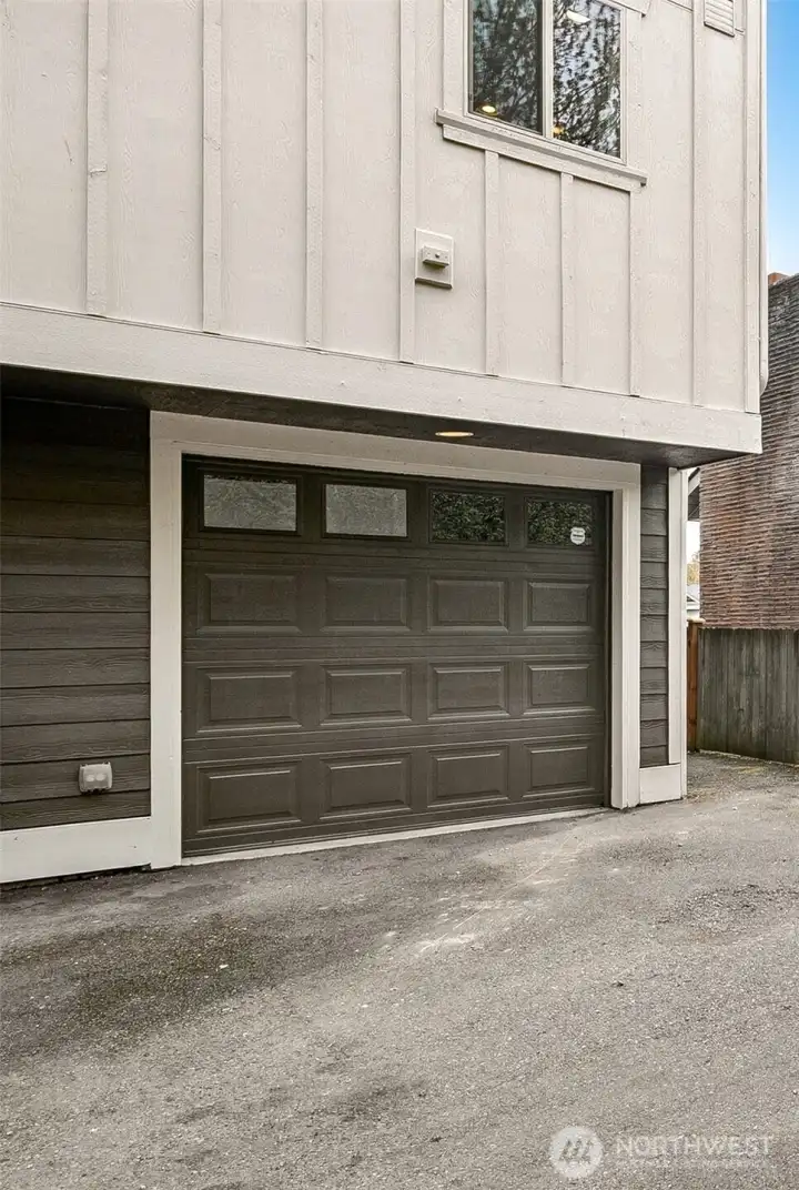 Single car garage with additional room for tools or storage.