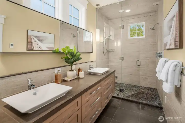 Primary bath with heated tile floors, double headed steam shower and double vanities