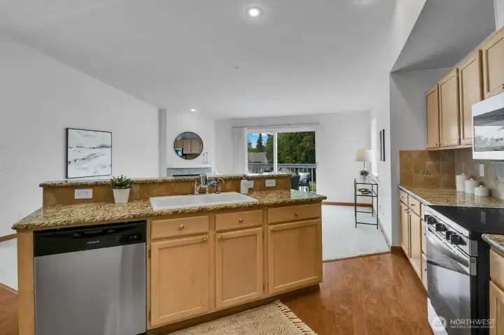 Kitchen open to the living and dining rooms, and balcony Kitchen open to the living and dining rooms, and balcony