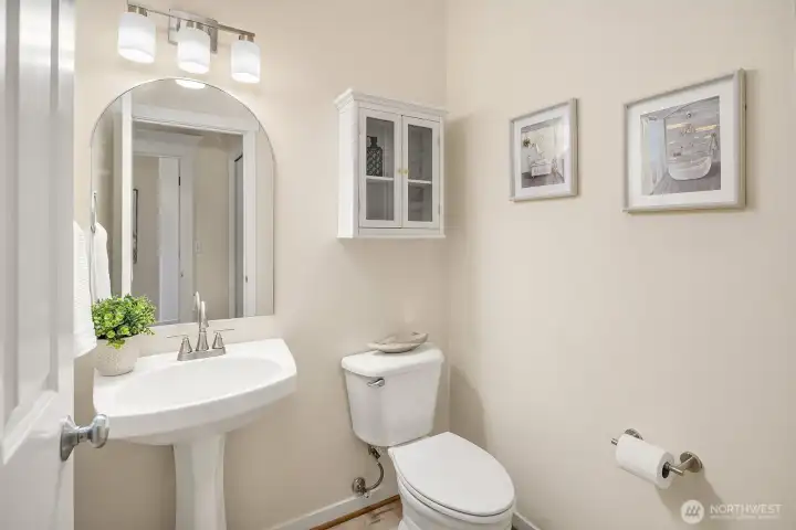 Main floor powder room with upgraded fixtures and hardware