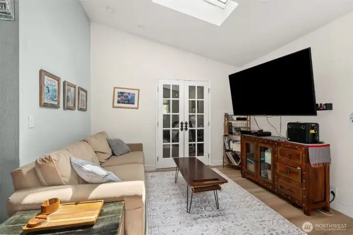 Living room opens to the den with french doors