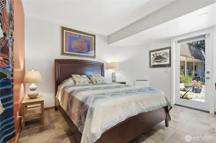 One of two main floor bedrooms.  This room features an exit on to the stone path and gardens.