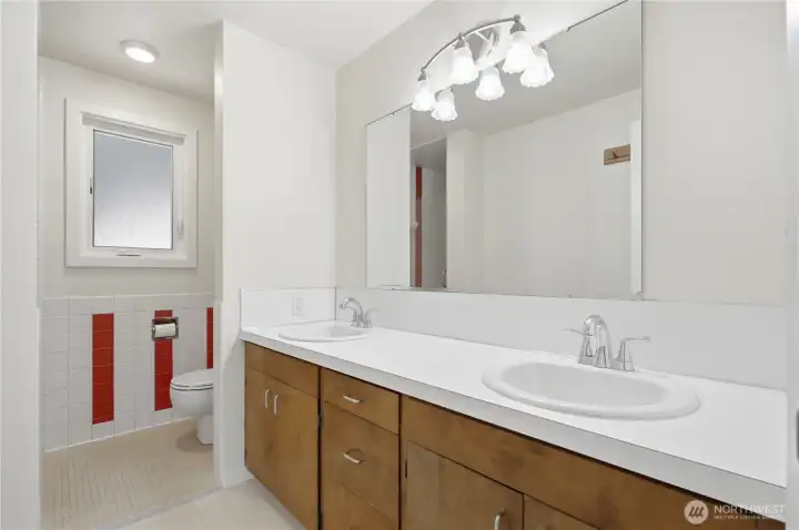 Main floor 3/4 bath with extra counter space is located between the two main floor bedrooms.
