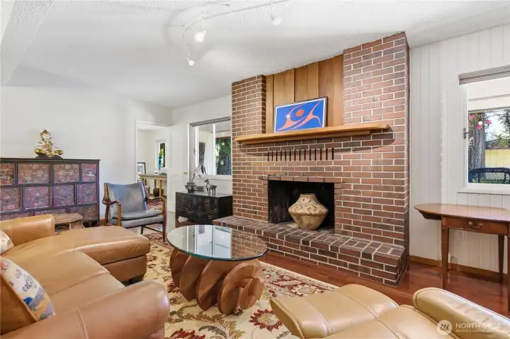 The brick faced wood burning fireplace is a focal point of the room.