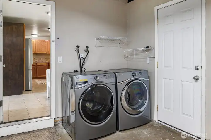 Full size washer/dryer just behind the door to the dining area.